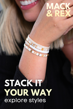 Close up of a woman wearing stacked bracelets and a black top