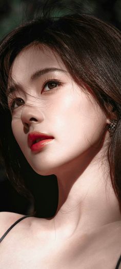Close up portrait of a woman with long hair and red lipstick