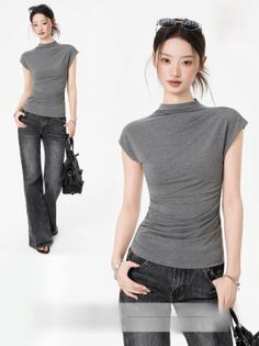 Woman in a gray top and wide-leg jeans with sunglasses on her head