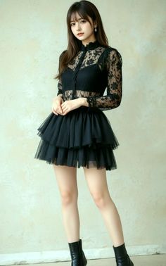Woman in a black lace top and tutu skirt posing indoors