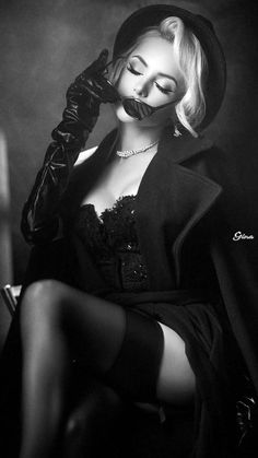 Woman in a hat, gloves, and corset with a provocative pose in black and white