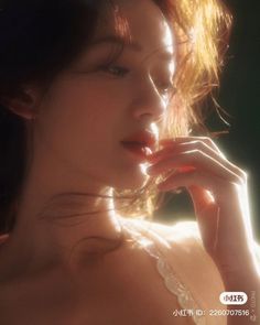 Woman with long hair in soft backlight with a warm tone