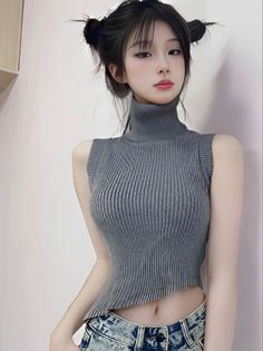 Woman with space buns wearing a sleeveless turtleneck and acid wash jeans