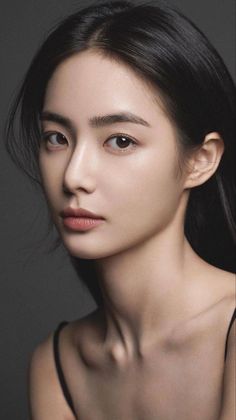 Woman with long black hair in a portrait with soft lighting