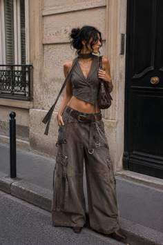 Woman in a cropped vest and cargo pants on a street