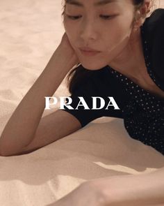 Woman in a polka dot dress lying on sandy ground with soft lighting