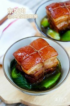 Two bowls of braised pork belly with green vegetables in a savory sauce