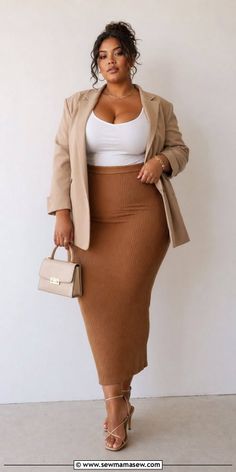 Woman in a blazer and midi skirt with a handbag and high heels