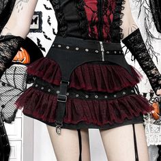 Person in gothic attire with a layered mini skirt and garter belt