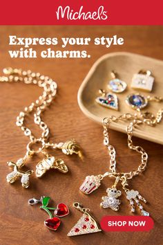 Collection of gold chains and various sparkling charms on a wooden surface