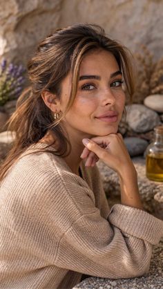 Woman with long hair and freckles wearing a knitted sweater outdoors