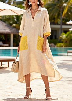 Woman in a beige linen dress with yellow pockets and high heels at a resort