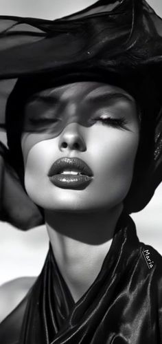 Black and white portrait of a woman with closed eyes and red lipstick, wearing a veil