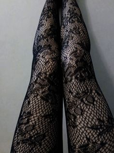Legs in black fishnet stockings with a lace pattern