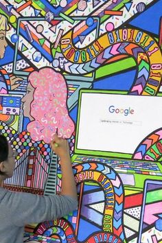 Woman painting a vibrant mural with computer and binary code motifs