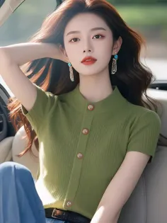 Woman with long brown hair wearing a green top and dangle earrings