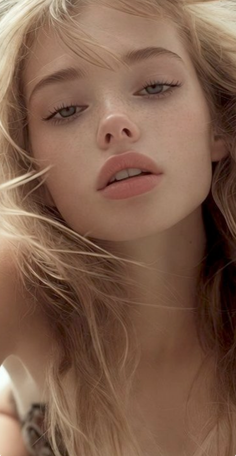 Close up portrait of a woman with blonde hair and freckles