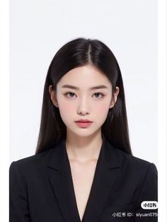 Woman with long black hair wearing a black suit against a white background