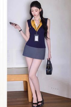 Woman in a mini skirt and sleeveless top holding a phone and bag indoors