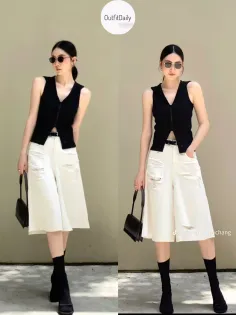 Woman in a black vest and white culottes posing outdoors