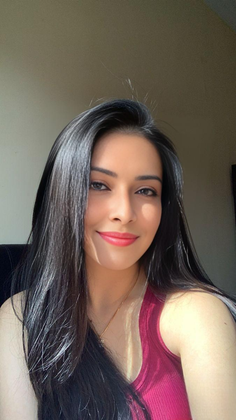 Woman with long black hair and red lipstick wearing a red top