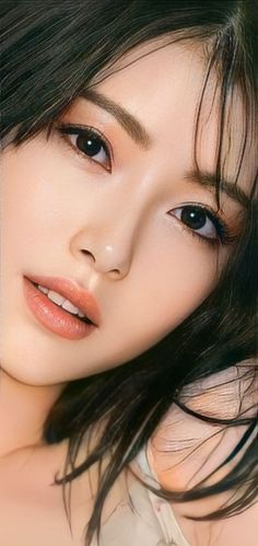 Close up portrait of a woman with black hair and soft lighting