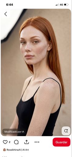 Woman with red hair and freckles wearing a black tank top