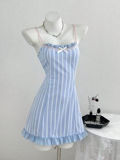 Blue and white striped dress with ruffle trim on a mannequin