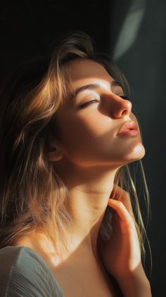 Woman with blonde hair in soft backlight, eyes closed, head tilted back