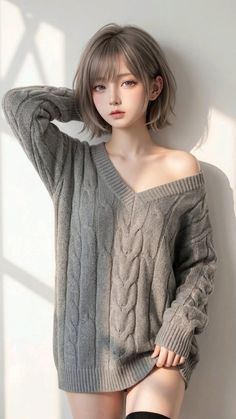 Woman with short grey hair wearing an off-shoulder grey sweater indoors