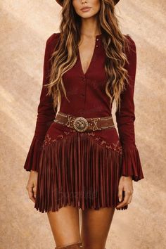 Woman in a red fringe dress and cowboy hat with exposed skin