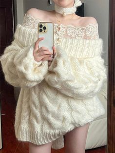 Person in an off-shoulder cable knit sweater with a lace top and pearl choker