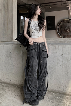 Woman with long black hair wearing a crop top and cargo pants outdoors