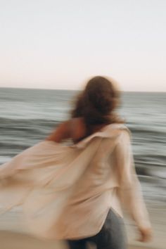 Woman with long hair walking on a beach with motion blur