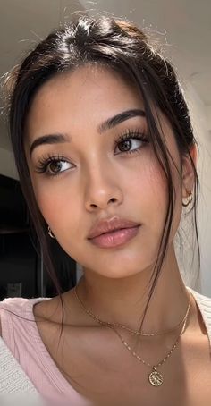 Close-up portrait of a woman with dark hair and natural makeup