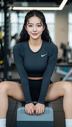 Woman in athletic wear sitting on a step in a gym