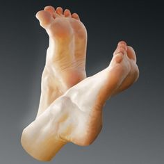 Two bare feet with visible soles against a dark background