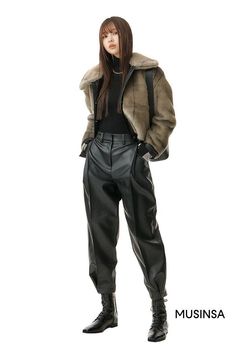 Woman in a faux fur jacket, black turtleneck, and leather pants