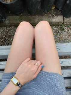 Person sitting on a bench with exposed legs and a short skirt