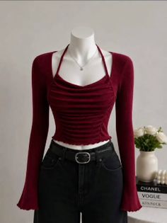 Mannequin wearing a red long-sleeve top and black jeans with a silver necklace