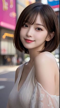 Woman with short brown hair in a white top outdoors