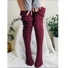 Person wearing burgundy cable knit thigh high socks and a grey sweater