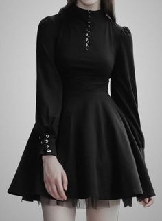 Woman in a black long-sleeved dress with a high collar and eyelet details