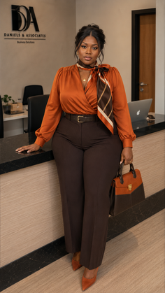 Woman in business attire with a handbag in an office setting