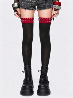 Person wearing black stockings with studded garters, denim shorts, and platform boots