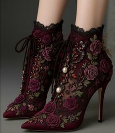 Pair of dark red high-heeled ankle boots with floral embroidery and pearls