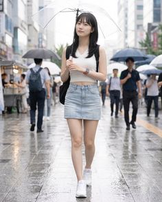 Woman with an umbrella walking on a wet city street