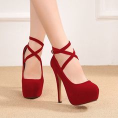 Pair of red suede platform high heels with ankle straps