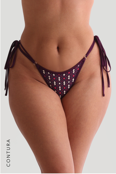 Close up of a woman wearing a patterned bikini bottom with tie sides