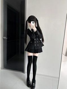 Person in a black school uniform with twin tails taking a mirror selfie